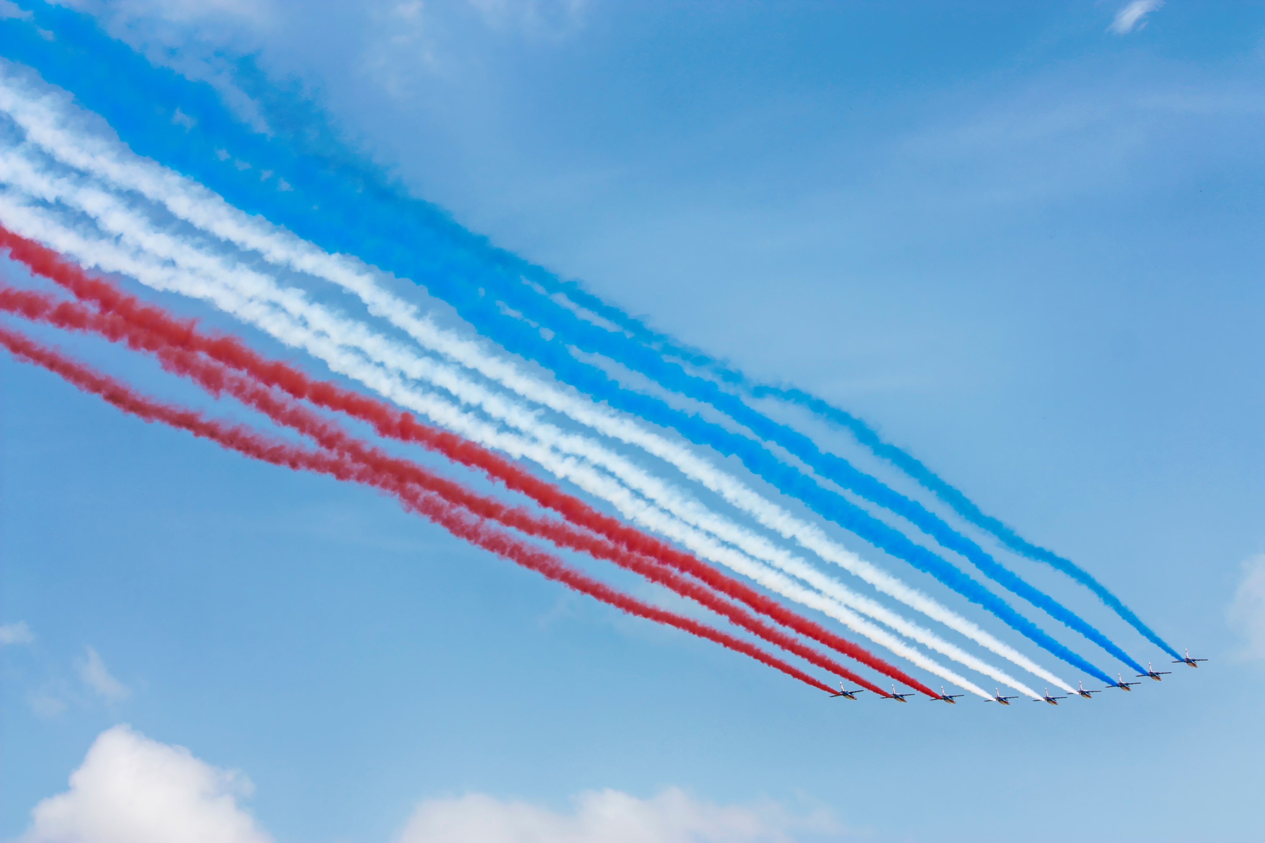 Airplane jets in sky making the flag of the France in smoke