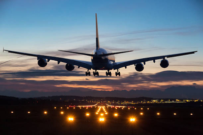 Plane at night over runway